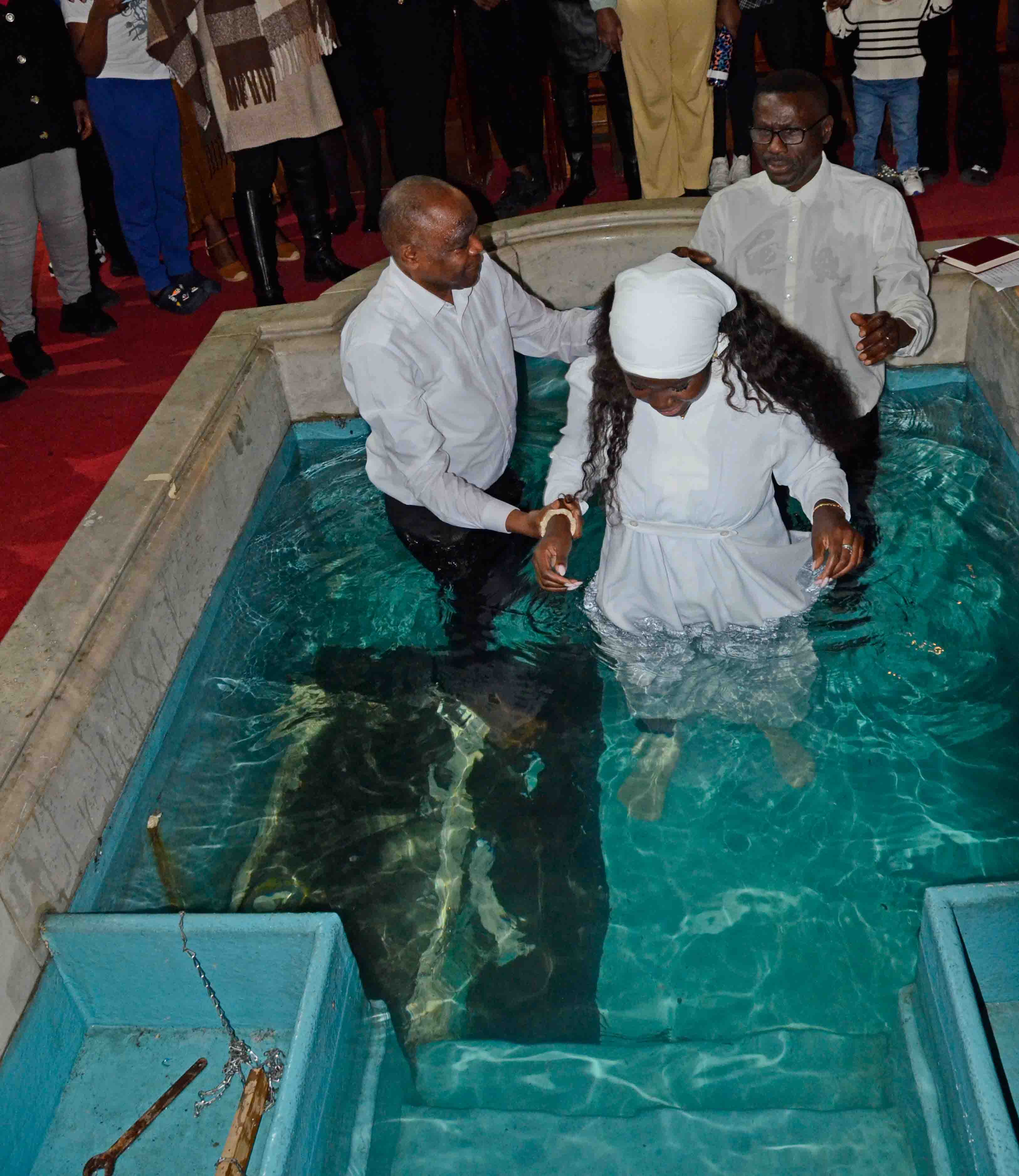 Pastor with candidate at the pool, about to be immersed