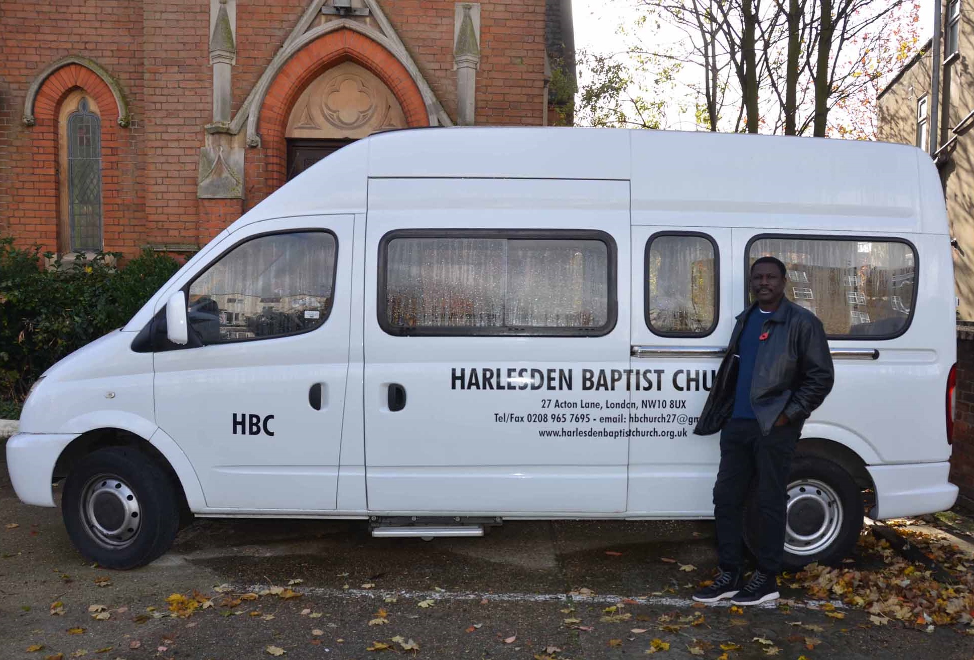 Pastor Cornelius Mereweather-Thompson with the HBC mini-van outside the church on Acton Lane