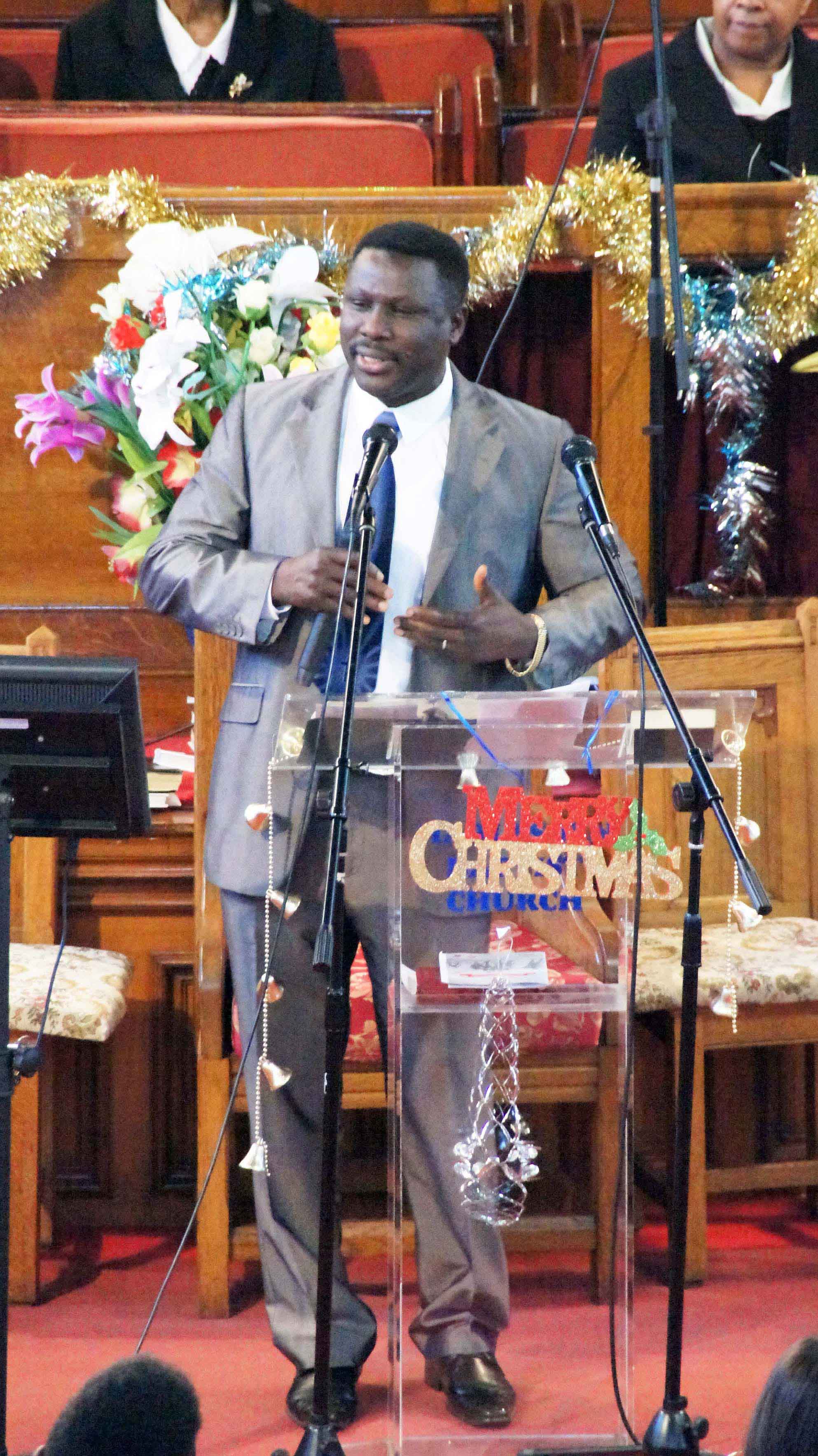 Pastor Cornelius Mereweather-Thompson preaching at a Christmas service